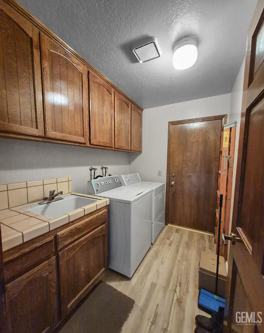 Undisclosed Address Lancaster, CA 93536 - Photo 12 of 22 a kitchen with a sink a refrigerator and cabinets