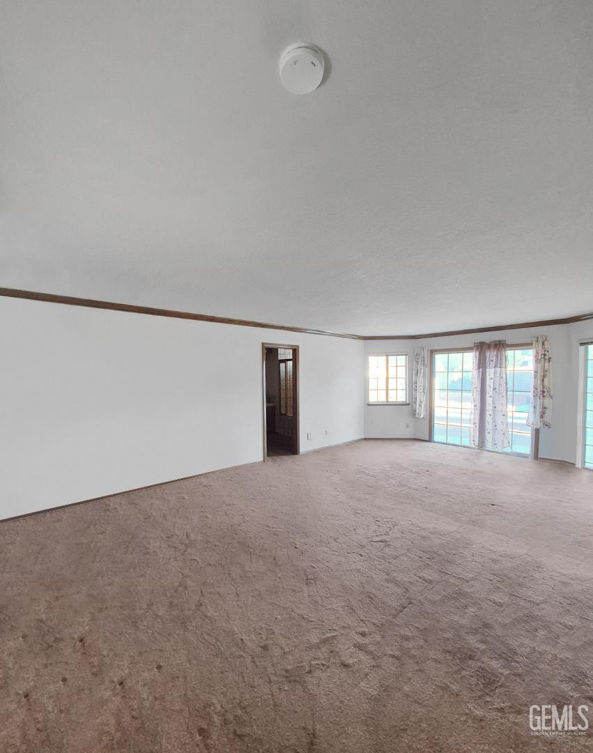 Undisclosed Address Lancaster, CA 93536 - Photo 13 of 22 a view of an empty room with a window and a kitchen