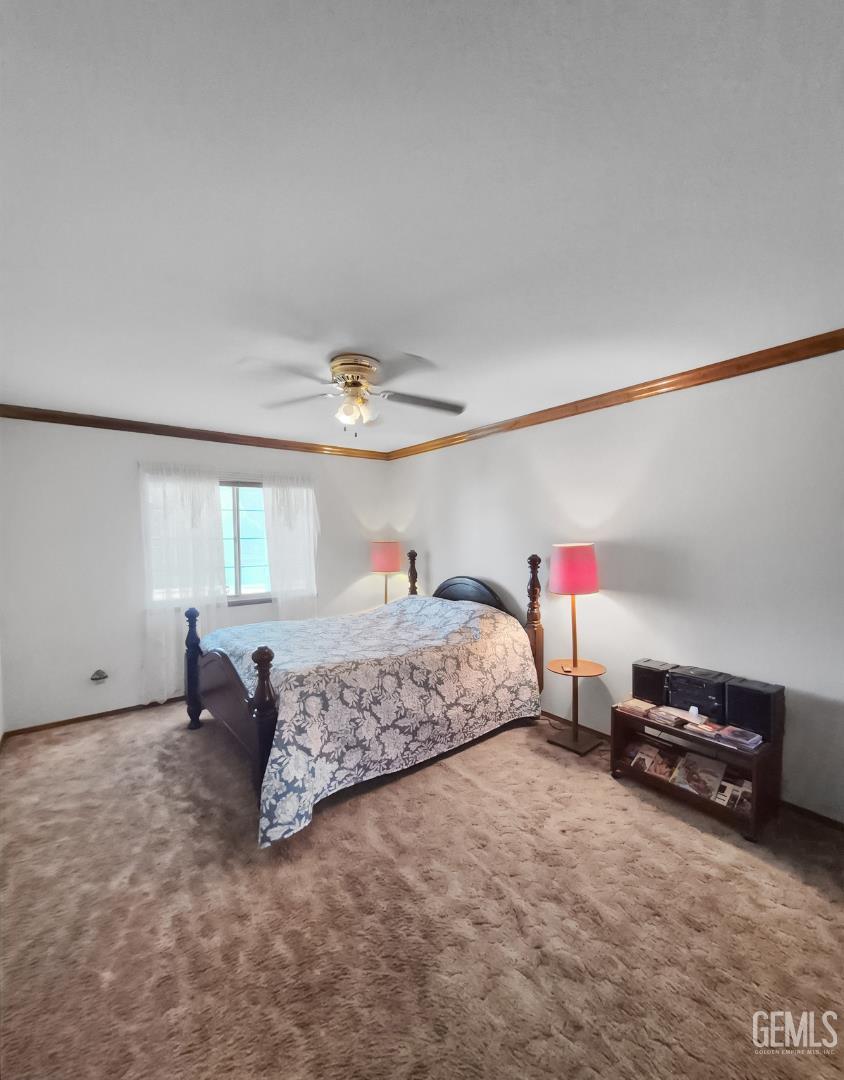 Undisclosed Address Lancaster, CA 93536 - Photo 17 of 22 a spacious bedroom with a bed and a ceiling fan