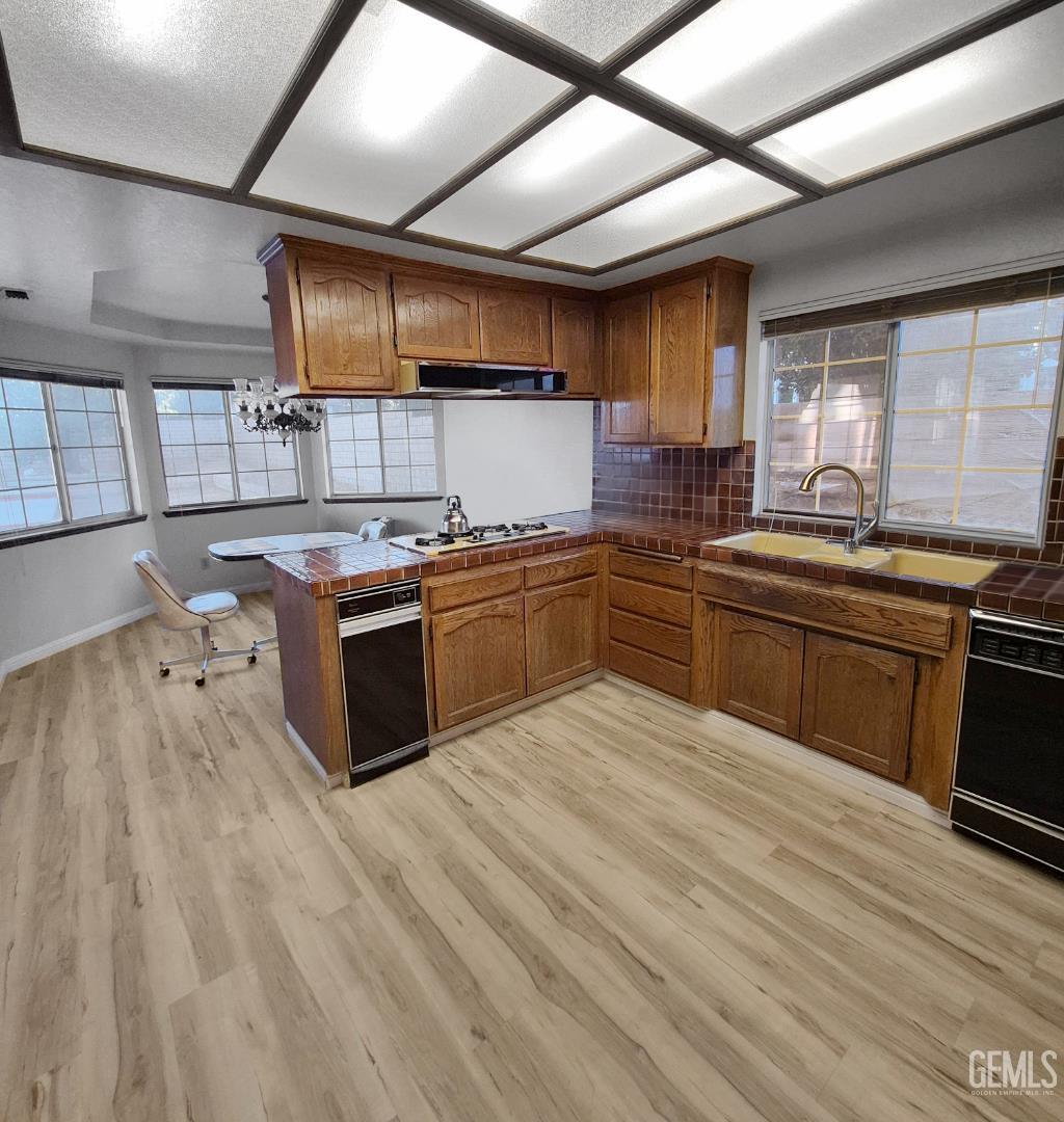 Undisclosed Address Lancaster, CA 93536 - Photo 8 of 22 a kitchen with stainless steel appliances granite countertop a stove sink and cabinets