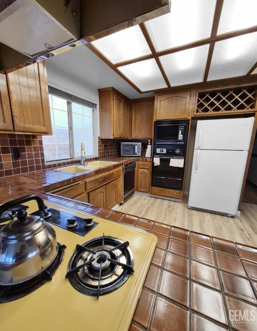 Undisclosed Address Lancaster, CA 93536 - Photo 9 of 22 a kitchen with a sink appliances and cabinets