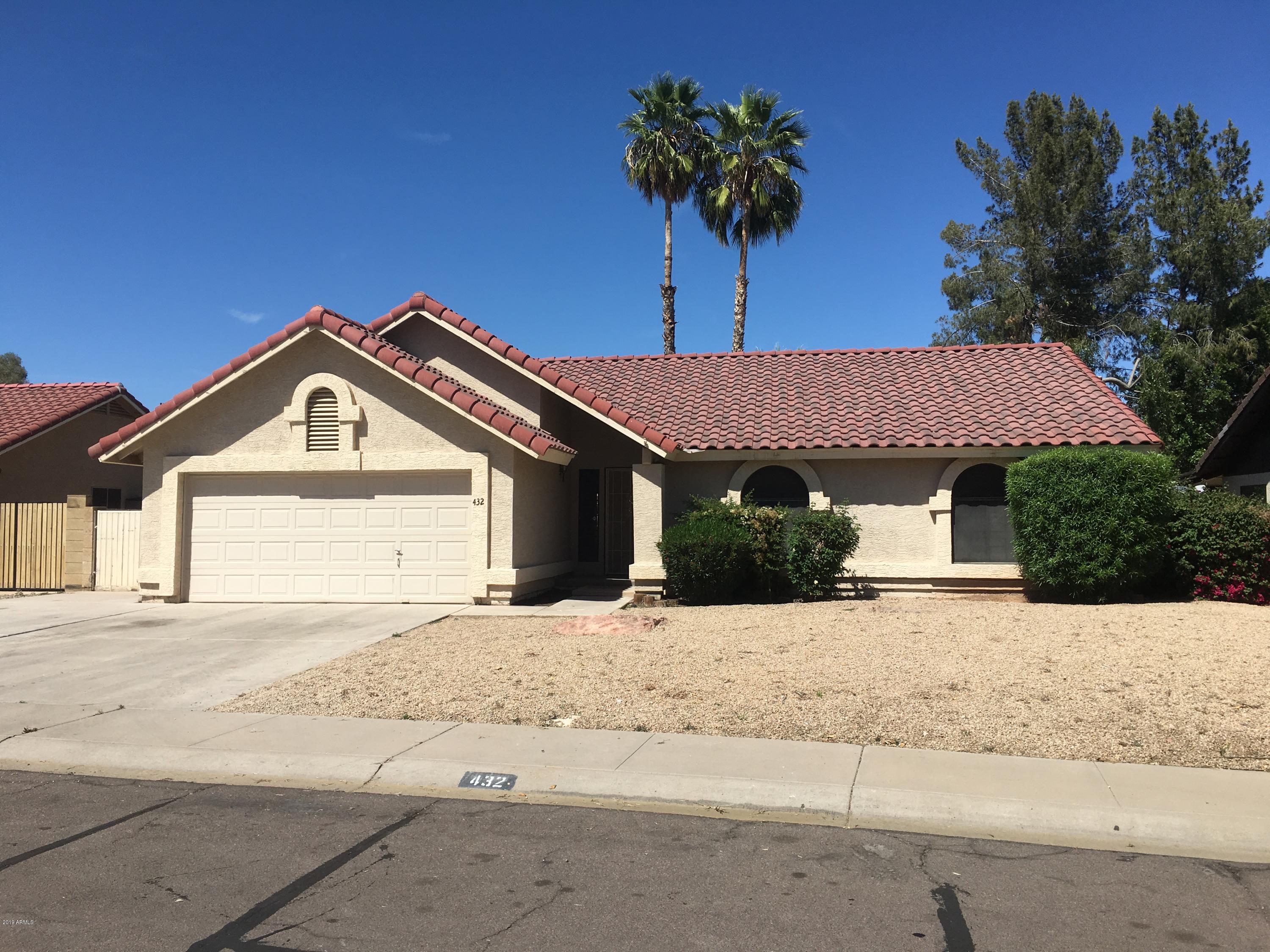 432 East Harwell Road Gilbert, AZ 85234 - Photo 2 of 17 a front view of a house with a yard and garage