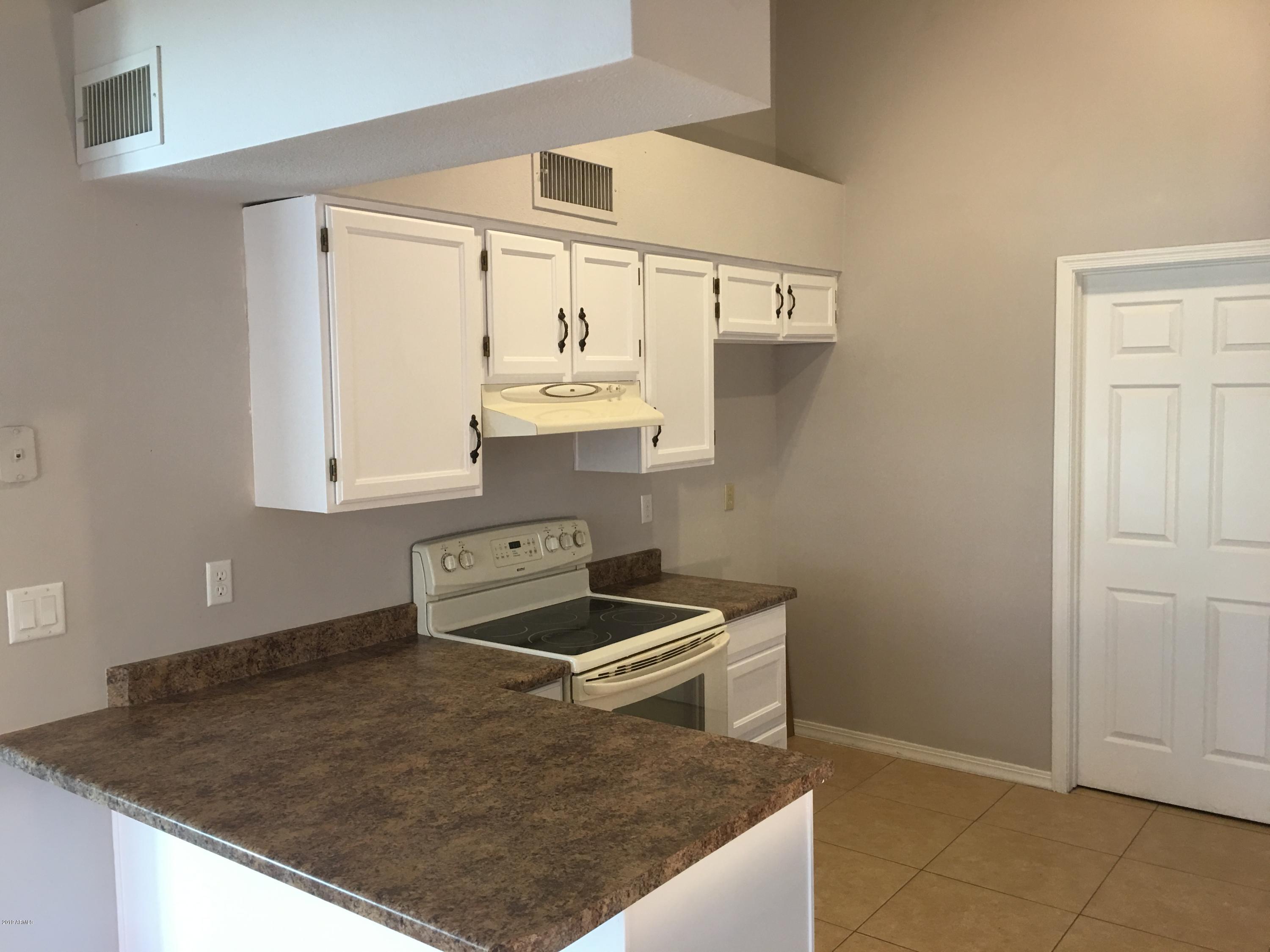 432 East Harwell Road Gilbert, AZ 85234 - Photo 4 of 17 a kitchen with stainless steel appliances granite countertop a sink and a stove