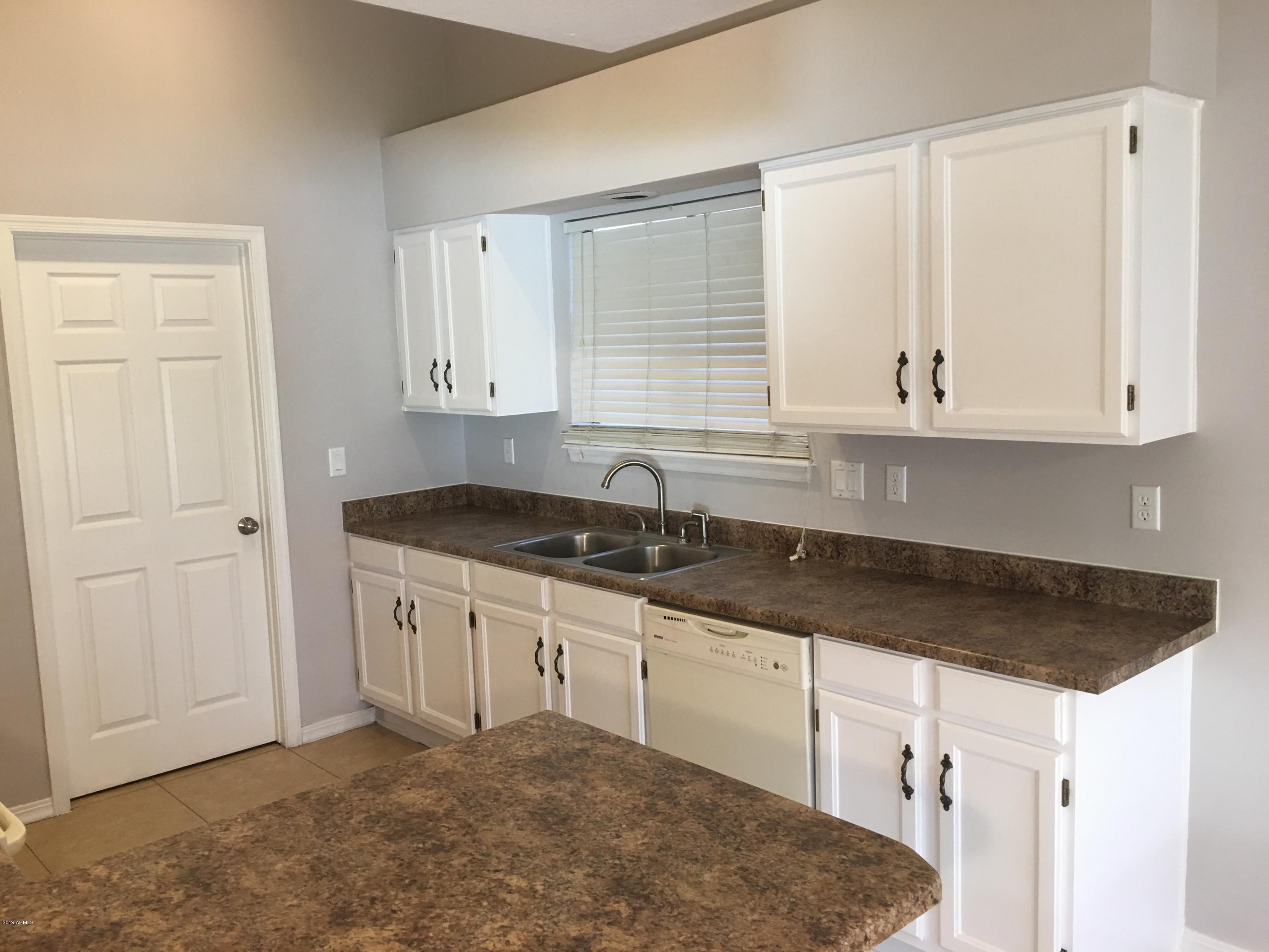 432 East Harwell Road Gilbert, AZ 85234 - Photo 5 of 17 a kitchen with granite countertop white cabinets and a stove