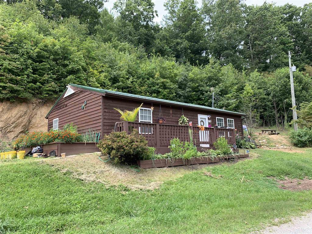 384 Camp Creek Road Northwest Riner, VA 24149 - Photo 1 of 12 a front view of a house with garden