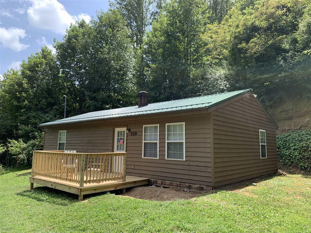 384 Camp Creek Road Northwest Riner, VA 24149 - Photo 4 of 12 a backyard of a house with a garden and deck
