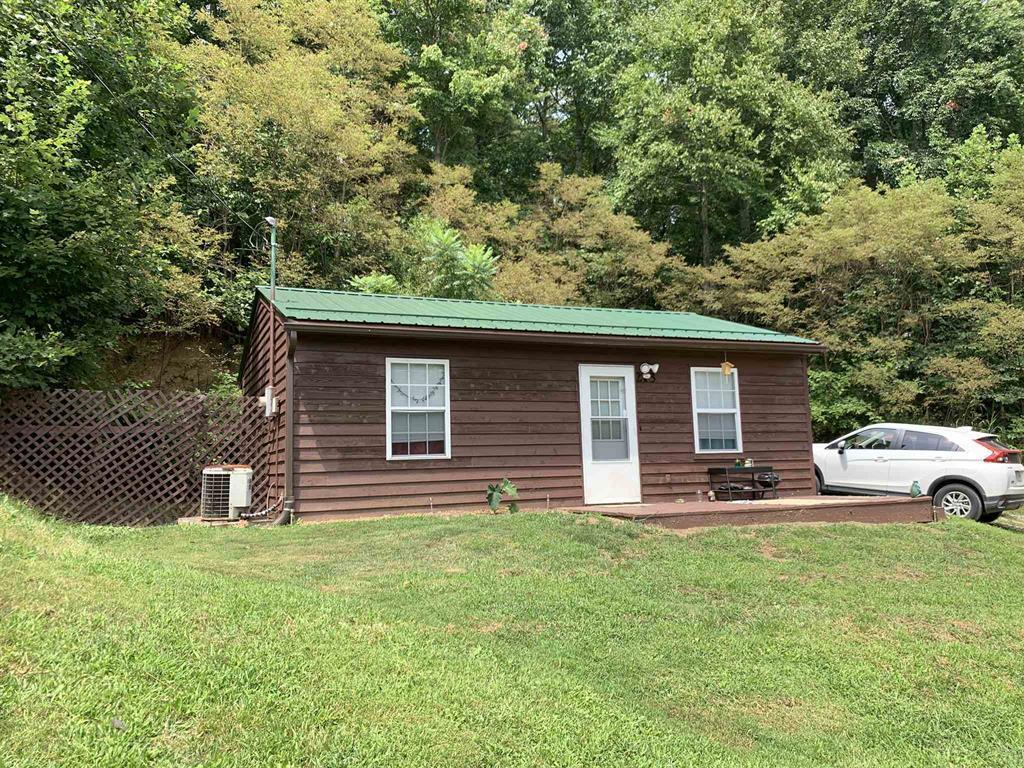 384 Camp Creek Road Northwest Riner, VA 24149 - Photo 8 of 12 a backyard of a house with table and chairs