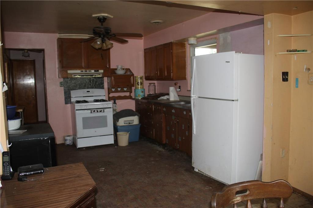 716 Kaye Avenue Monaca, PA 15061 - Photo 6 of 9 a kitchen with a refrigerator and a stove
