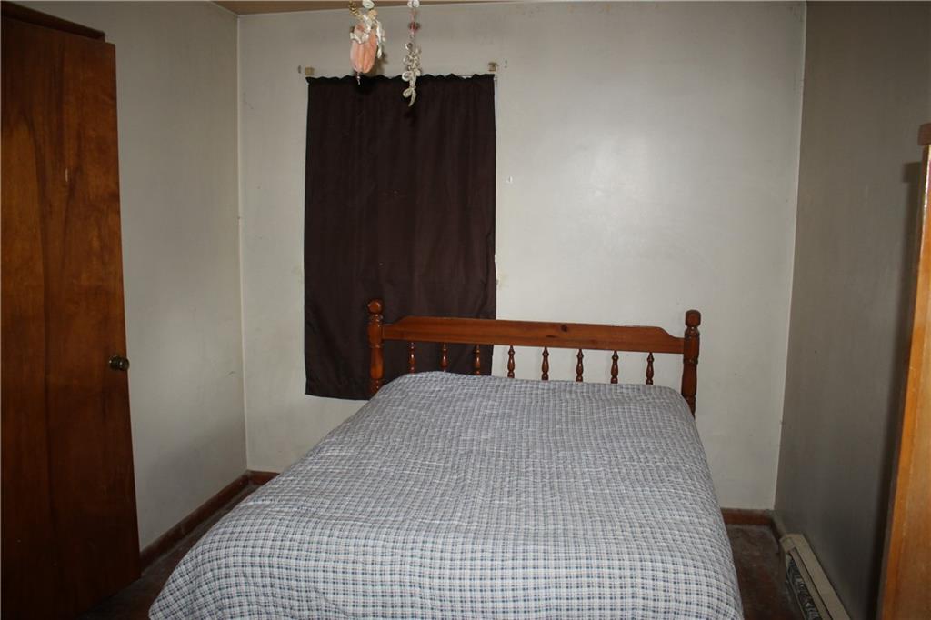 716 Kaye Avenue Monaca, PA 15061 - Photo 7 of 9 a bedroom with a bed and a table