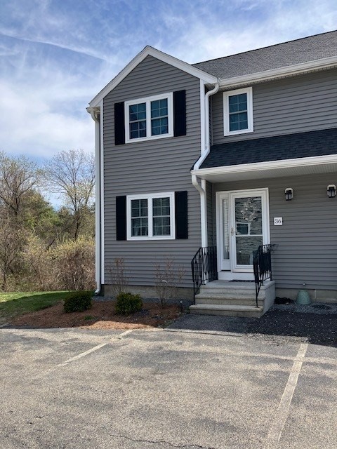 34 Lowell Road, Unit 36 Pepperell, MA 01463 - Photo 1 of 12 a front view of a house with a yard