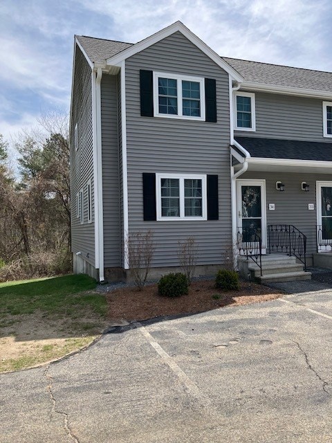 34 Lowell Road, Unit 36 Pepperell, MA 01463 - Photo 11 of 12 a front view of a house with garden