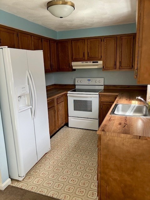 34 Lowell Road, Unit 36 Pepperell, MA 01463 - Photo 2 of 12 a kitchen with a refrigerator sink and cabinets