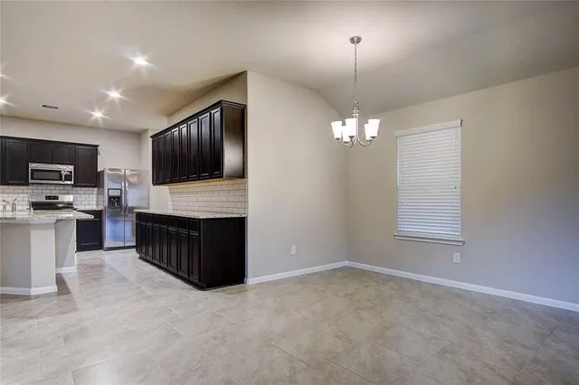 a kitchen with a refrigerator and microwave