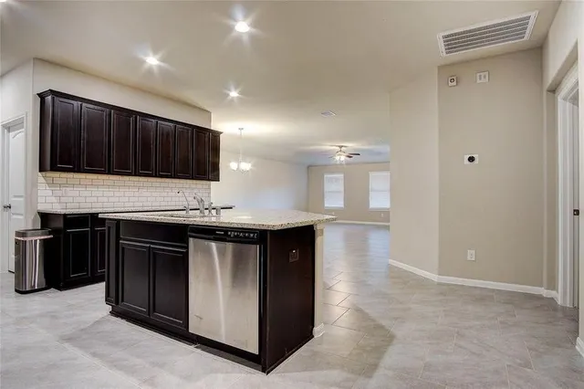 a kitchen with stainless steel appliances granite countertop a stove and a refrigerator