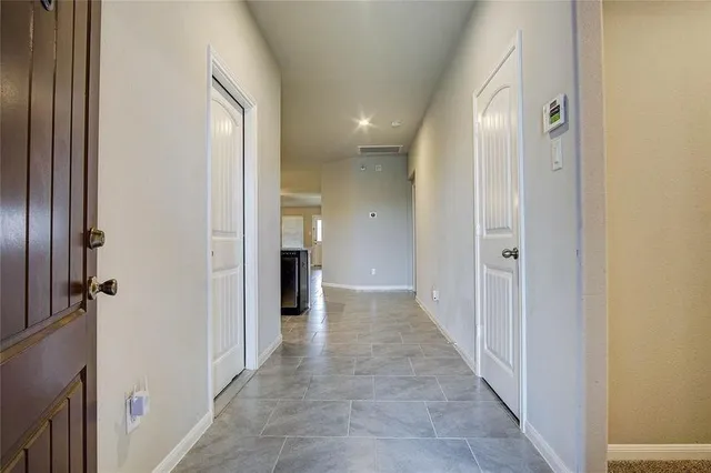 a view of a hallway with wooden shelves