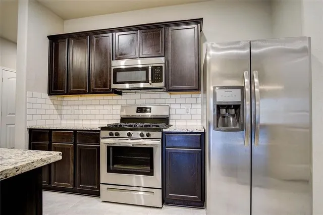 a kitchen with a refrigerator stove and microwave
