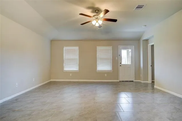 a view of an empty room with a window