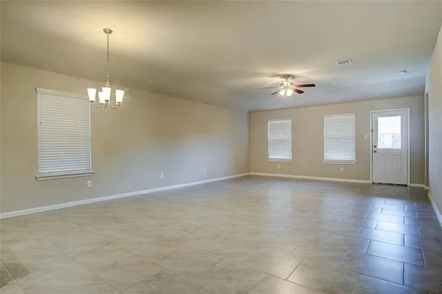 a view of a room with window and chandelier fan