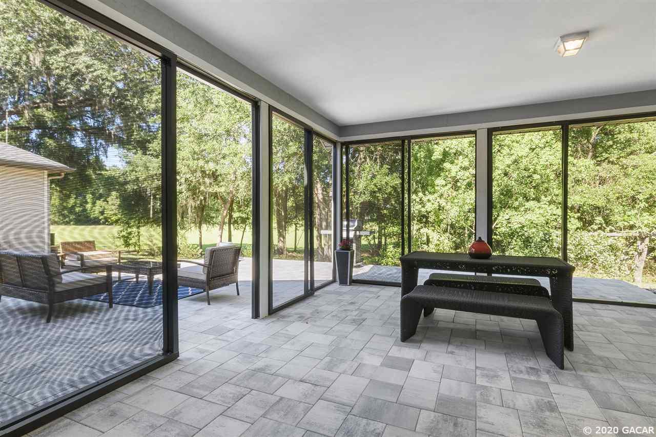 8321 Southwest 75th Road Gainesville, FL 32608 - Photo 3 of 29 Enjoy outdoors with no neighbor behind you. New extended pavers back patio with sliding screen doors.