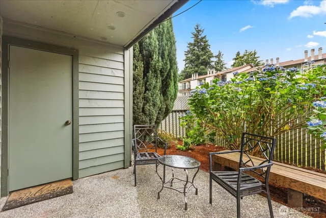 a view of a chairs and table in patio