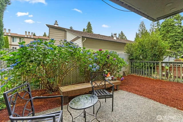 a backyard of a house with table and chairs