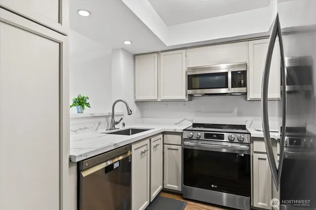 a kitchen with a stove microwave and sink