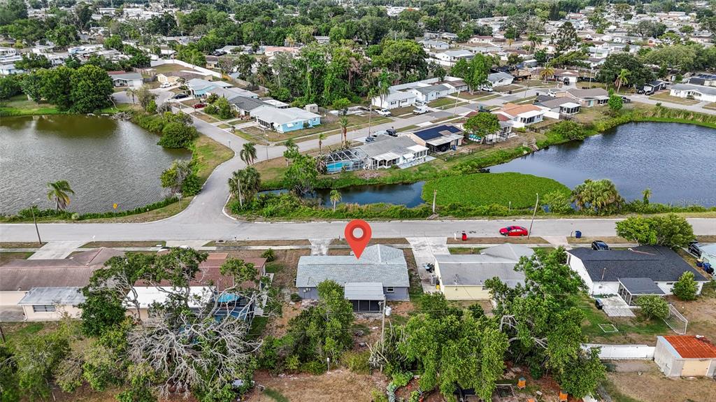 1623 Plum Tree Road Holiday, FL 34690 - Photo 32 of 33 an aerial view of a house with a yard and lake view