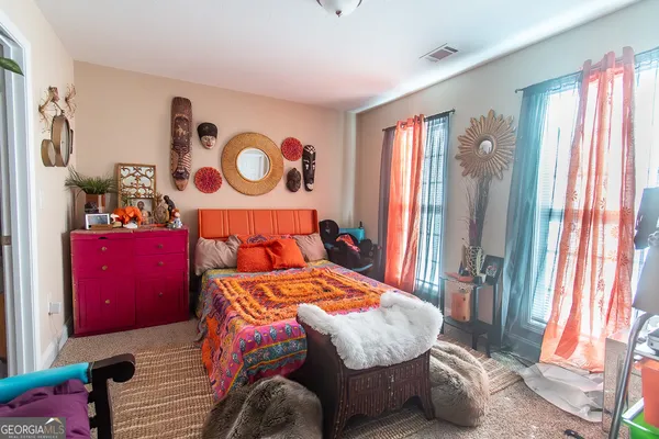 a bedroom with a bed and a window