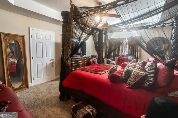 a bedroom with a bed and a mirror