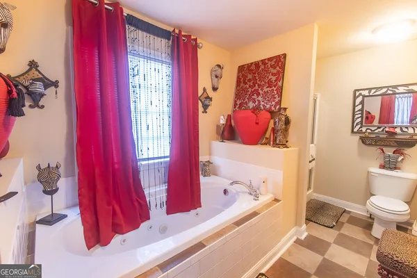 a bathroom with a bathtub shower sink and toilet