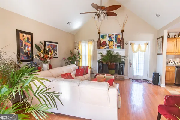 a living room with dining table furniture and a chandelier