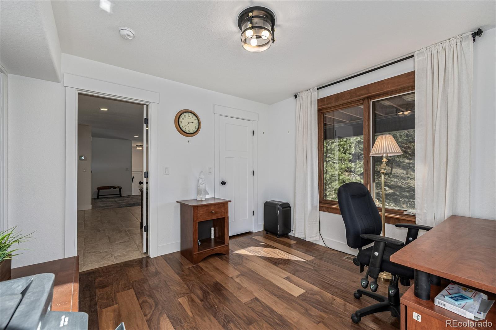 663 Brookside Drive Bailey, CO 80421 - Photo 29 of 47 a view of a workspace with furniture and a window