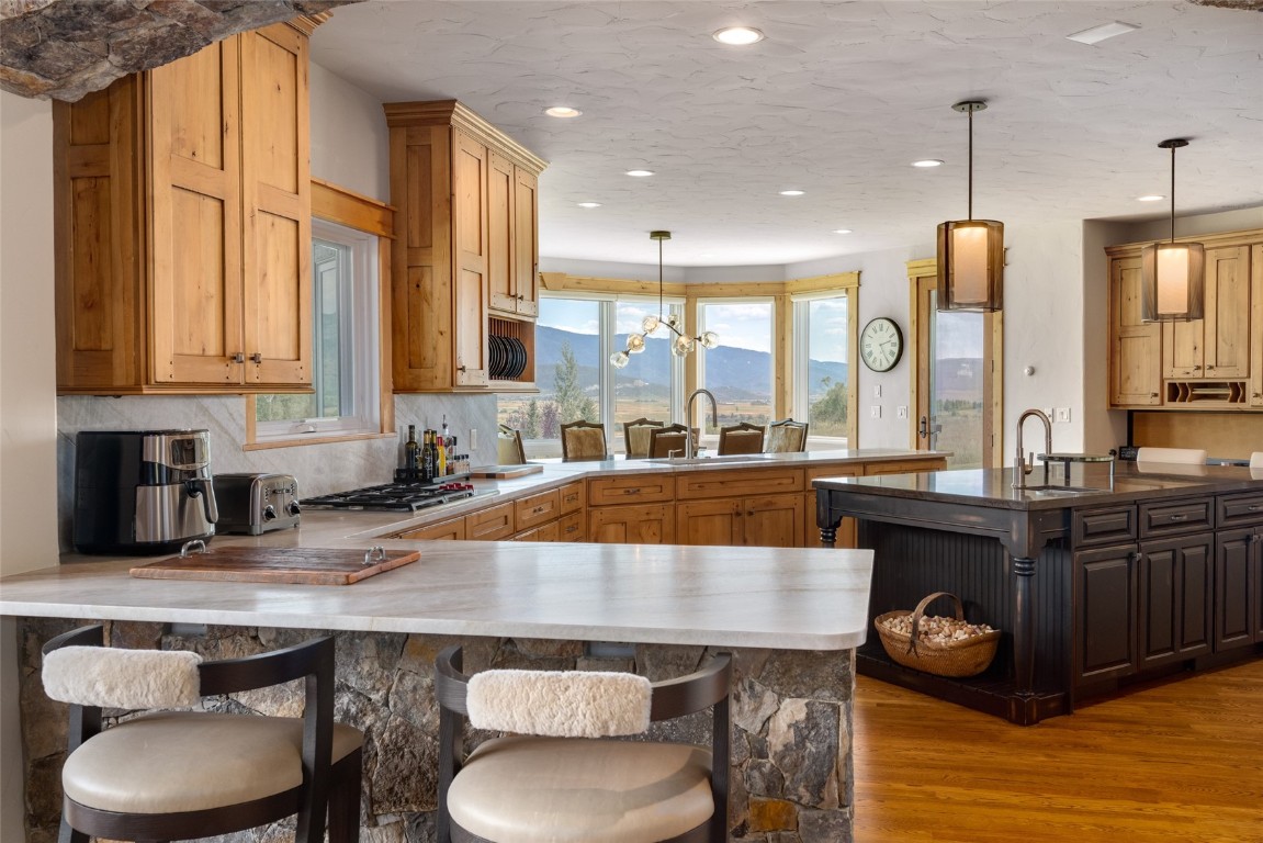 31105 Country Side Road Steamboat Springs, CO 80487 - Photo 11 of 50 a kitchen with stainless steel appliances granite countertop a stove a sink and a refrigerator