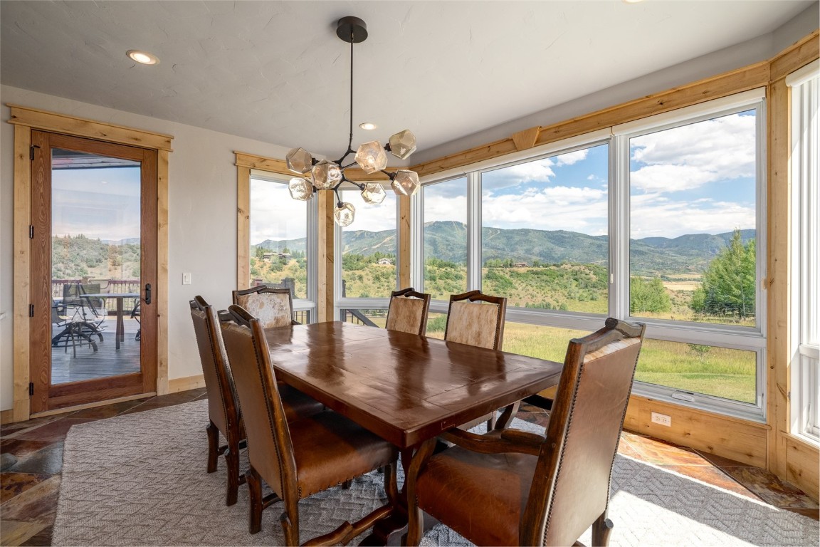 31105 Country Side Road Steamboat Springs, CO 80487 - Photo 15 of 50 a view of a dining room with furniture window and wooden floor