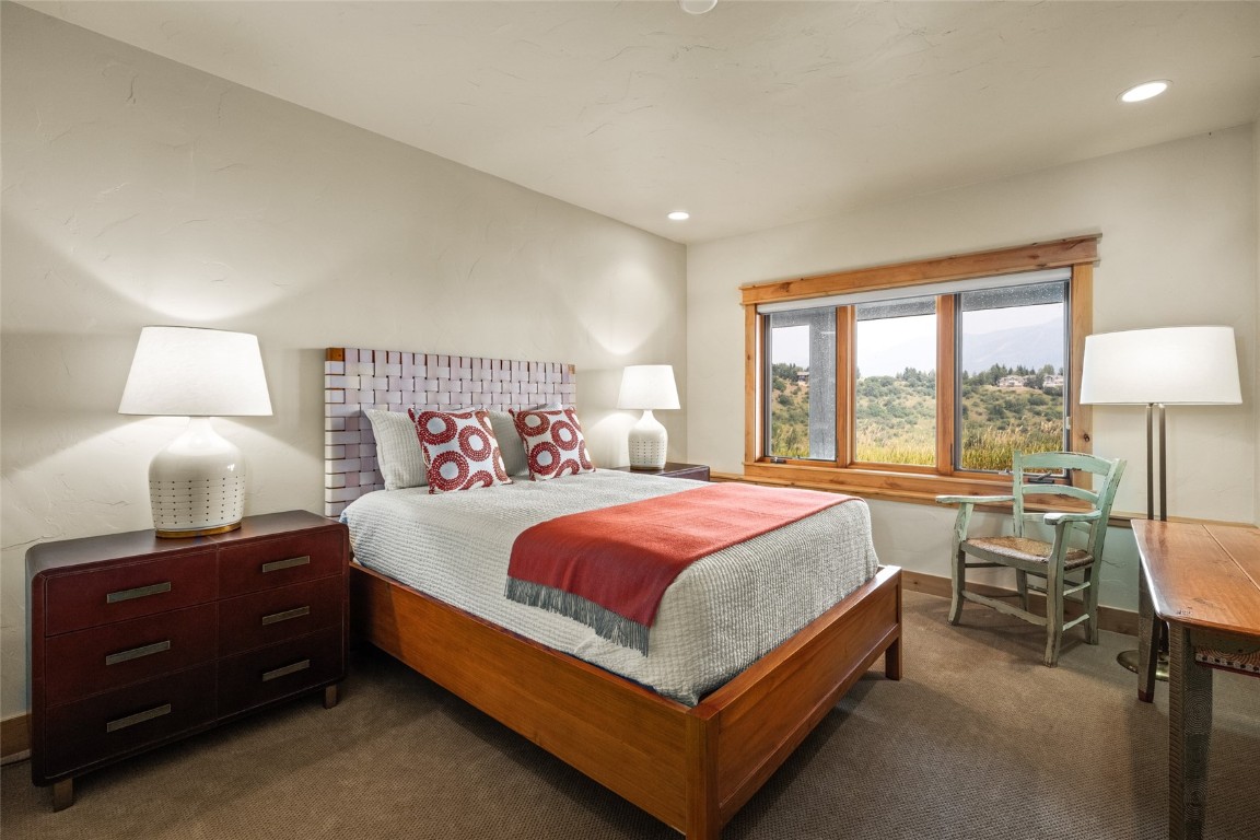 31105 Country Side Road Steamboat Springs, CO 80487 - Photo 40 of 50 a bed room with a bed and a lamp