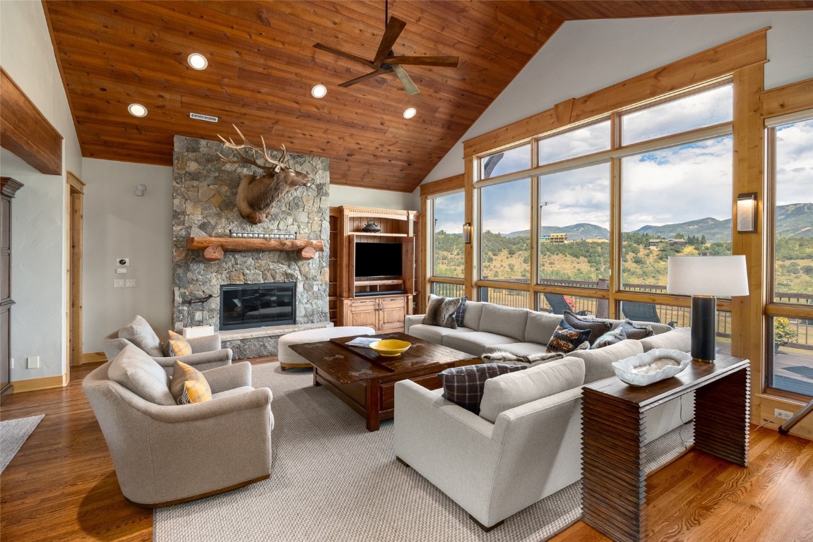 31105 Country Side Road Steamboat Springs, CO 80487 - Photo 4 of 50 a living room with furniture large window and a fireplace