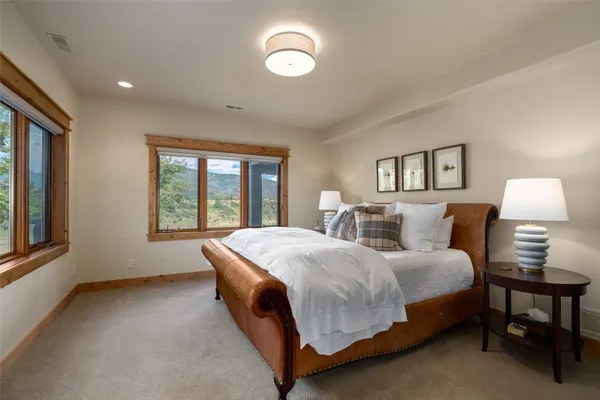 a spacious bedroom with a bed and a window