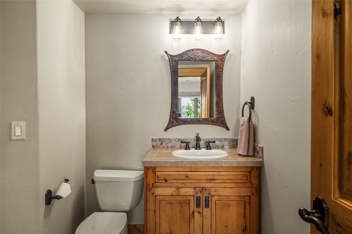 31105 Country Side Road Steamboat Springs, CO 80487 - Photo 46 of 50 a bathroom with a toilet sink and mirror