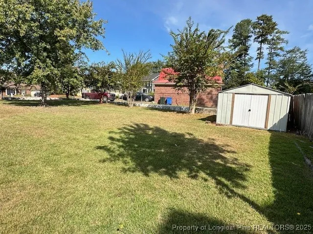 a view of a house with a yard and tree s