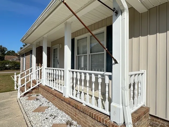 a view of a wooden house with a porch