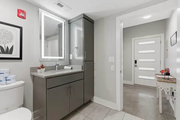 a bathroom with a toilet sink and a mirror