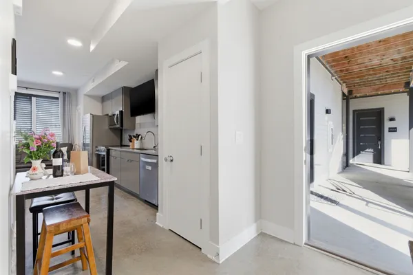 a kitchen with a refrigerator and a stove top oven