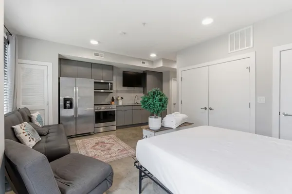 a bedroom with a large bed and furniture