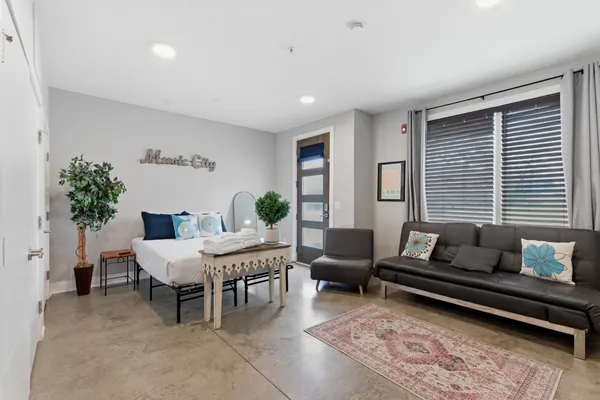 a living room with furniture and a potted plant