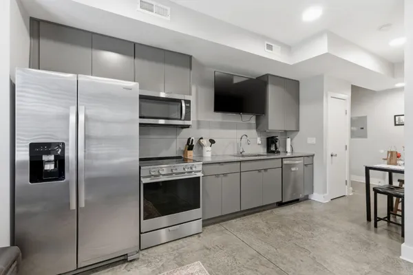 a kitchen with a sink stainless steel appliances and cabinets