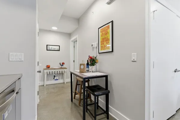 a view of a room that has a table and a chair in it