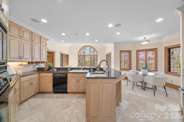 a kitchen with stainless steel appliances granite countertop a sink and cabinets