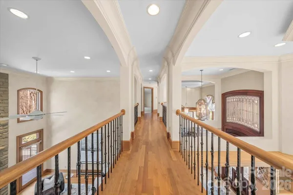 a view of entryway and hall with wooden floor