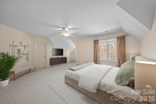 a bedroom with a bed flat screen tv and a couch