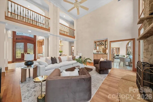 a living room with furniture fireplace and a large window